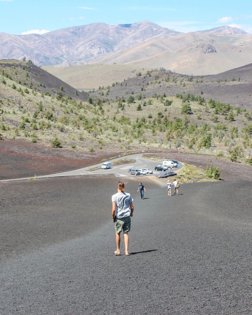 Hiking back down Inferno Cone at Craters of the Moon National Monument and Preserve in Idaho.