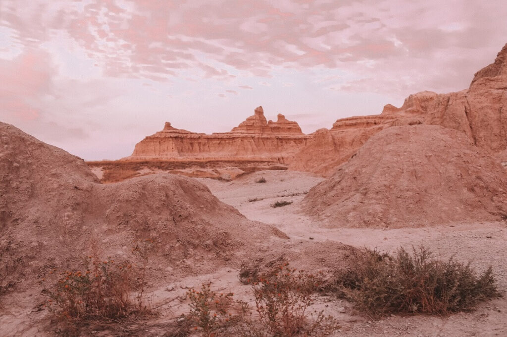 Hiking the Notch Trail at sunset in Badlands National Park.
