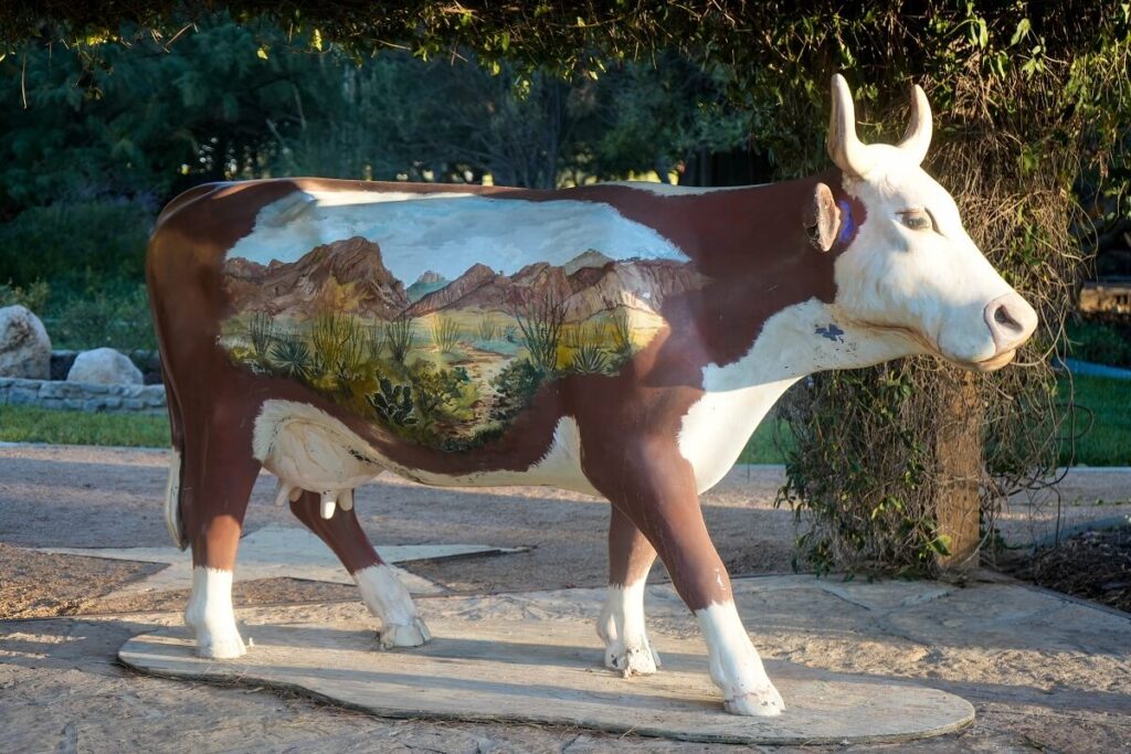A mural painted on a cow statue at Gage Park in Marathon, West Texas.